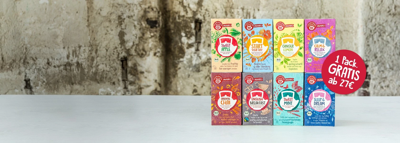 Acht farbenfrohe Teeboxen auf weißem Untergrund; rosa Kreis bietet „1 Packung. Gratis ab 27 €.“.